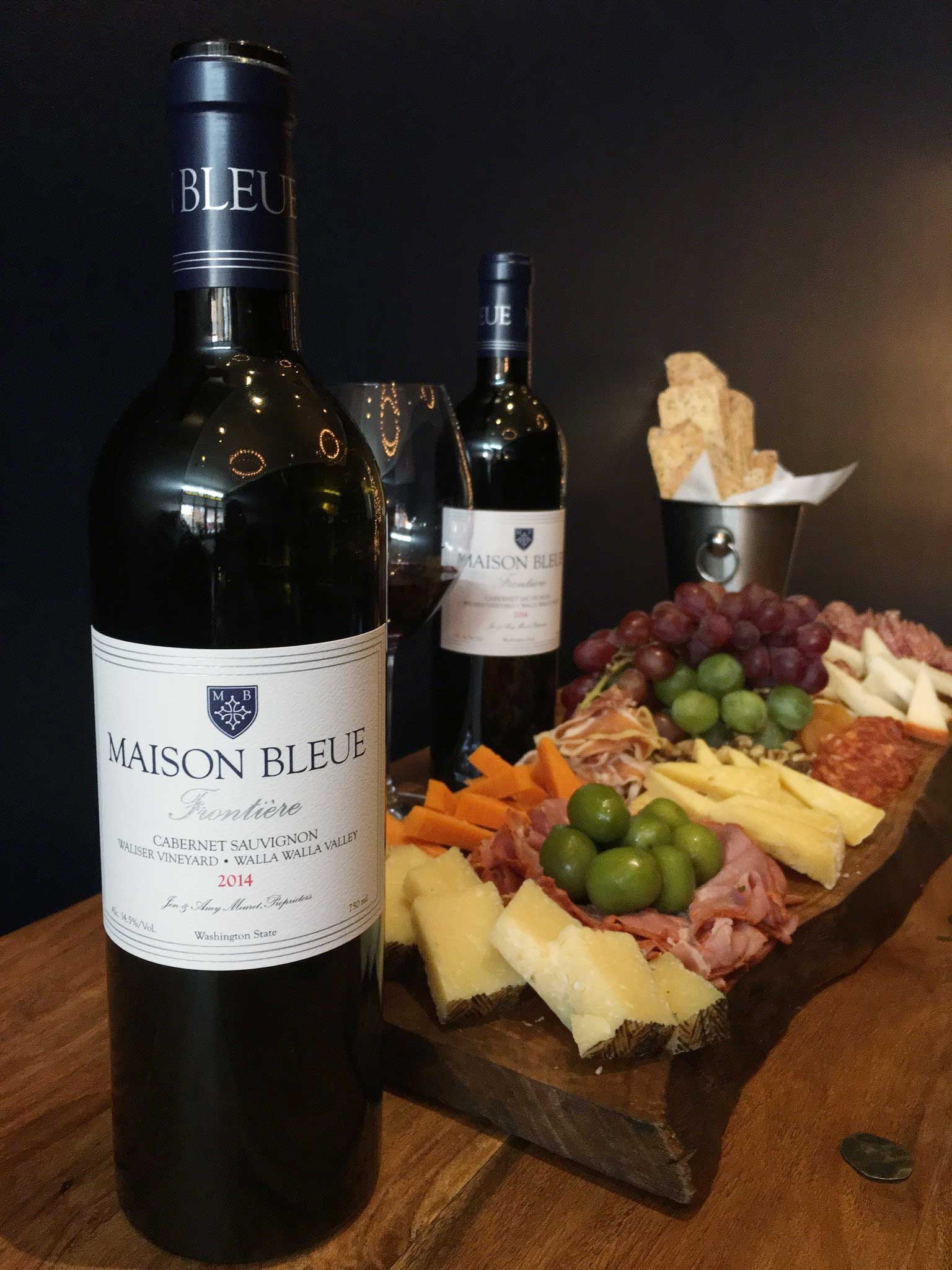 Maison Bleue bottles with a charcuterie platter