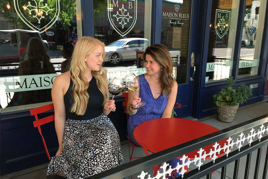 two people enjoying wine on the patio outside the tasting room